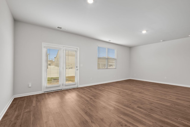 unfurnished room with dark hardwood / wood-style floors