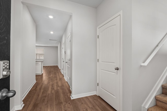 corridor with dark hardwood / wood-style flooring