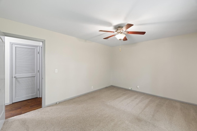 spare room with carpet floors and ceiling fan