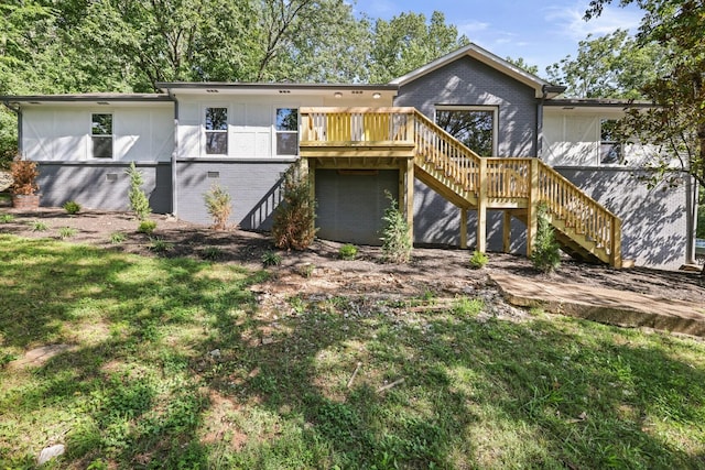 back of property with a lawn and a deck