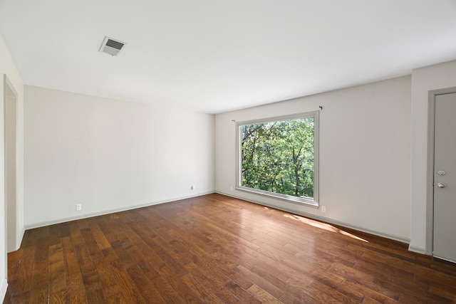 unfurnished room with dark hardwood / wood-style flooring