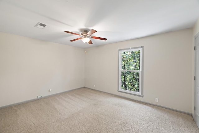 carpeted spare room with ceiling fan