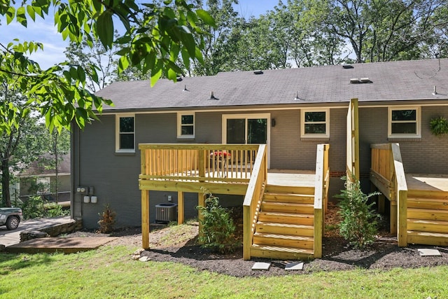 rear view of house featuring central AC unit and a deck