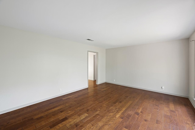 spare room with dark wood-type flooring