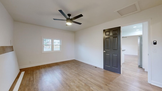 unfurnished room with ceiling fan and light wood-type flooring