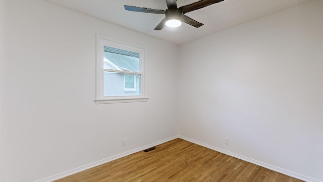 spare room with ceiling fan and wood-type flooring