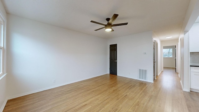 empty room with light hardwood / wood-style floors and ceiling fan