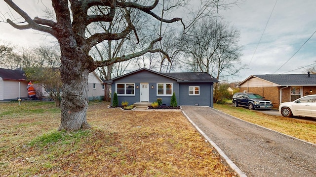 ranch-style home with a front lawn