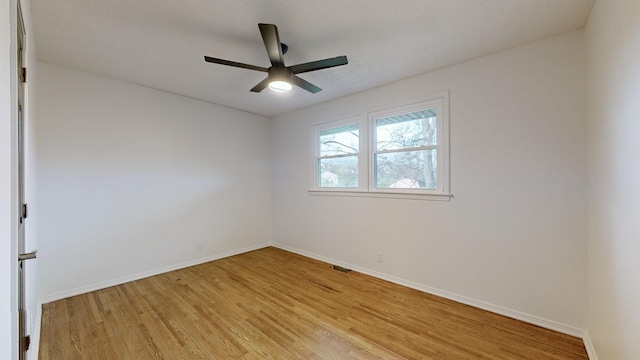 spare room with light wood-type flooring and ceiling fan