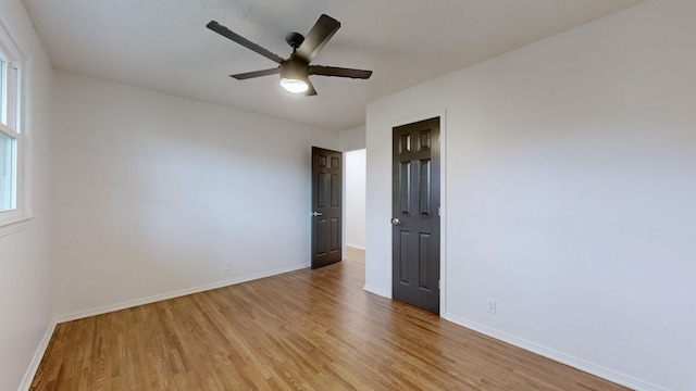 spare room featuring light hardwood / wood-style floors and ceiling fan