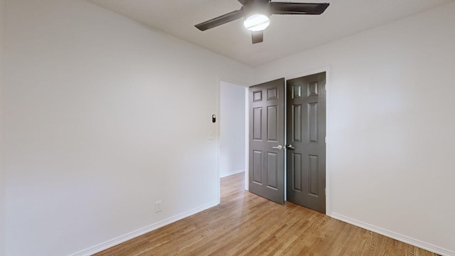 unfurnished room with ceiling fan and light wood-type flooring