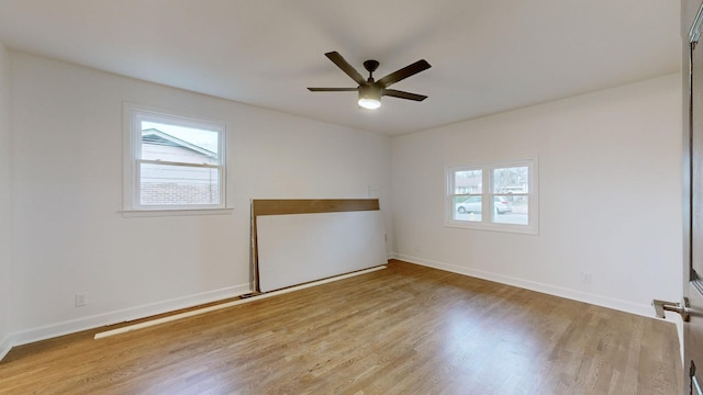 spare room with light hardwood / wood-style flooring and ceiling fan