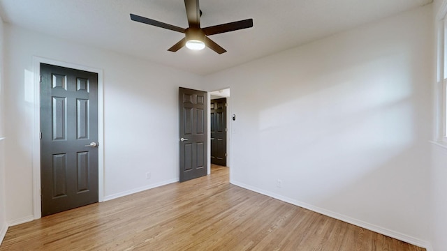 unfurnished bedroom with ceiling fan and light wood-type flooring