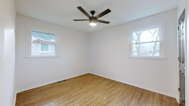 spare room with light hardwood / wood-style floors and ceiling fan