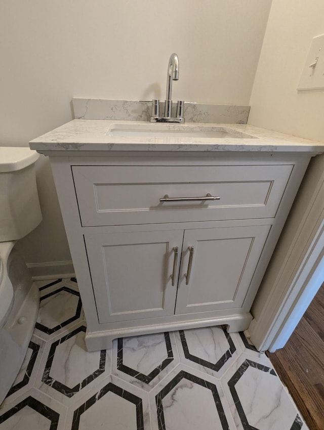 bathroom featuring vanity and toilet