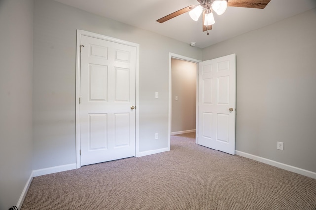 unfurnished bedroom with carpet, ceiling fan, and a closet