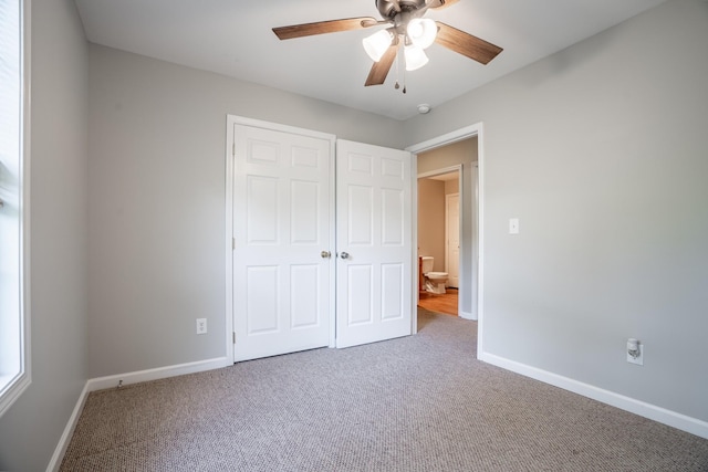 unfurnished bedroom with carpet floors, a closet, and ceiling fan