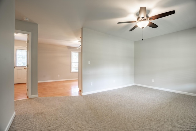 carpeted empty room featuring ceiling fan