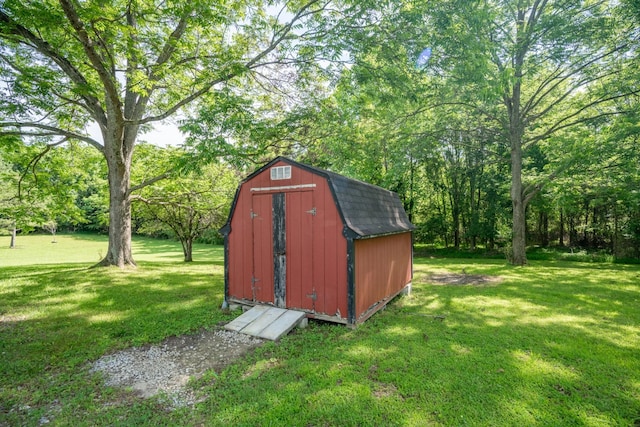 view of outbuilding featuring a yard