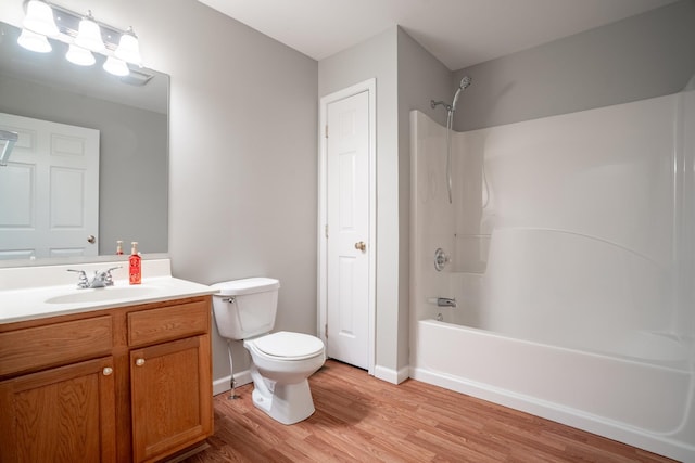 full bathroom with toilet, vanity, tub / shower combination, and hardwood / wood-style flooring