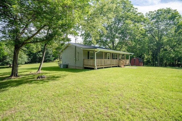 view of yard with covered porch and a storage unit