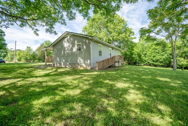 view of property exterior with a lawn and a wooden deck