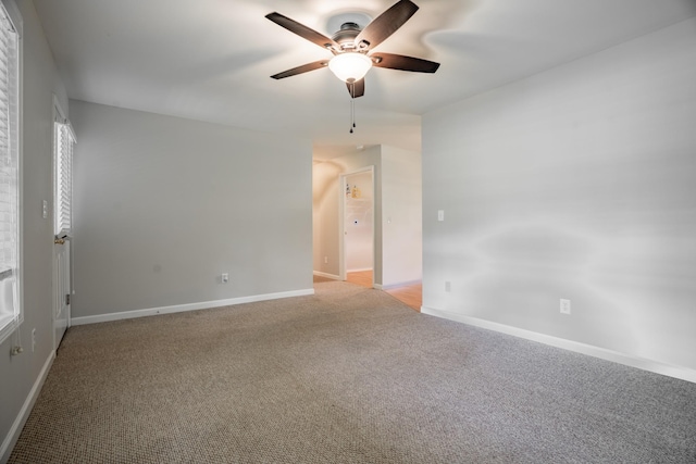 empty room with ceiling fan and light colored carpet