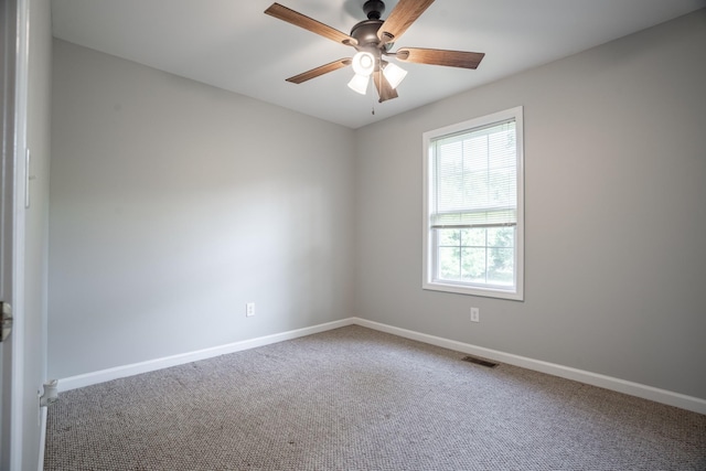 spare room with carpet flooring and ceiling fan