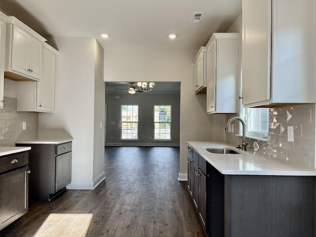 kitchen featuring backsplash, sink, ceiling fan, dark hardwood / wood-style floors, and white cabinetry