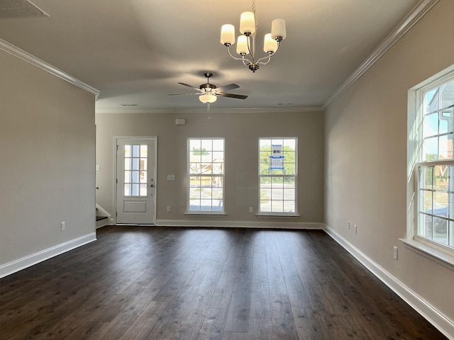 spare room featuring crown molding, dark wood-type flooring, and ceiling fan with notable chandelier