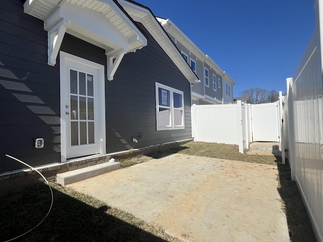 exterior space featuring a patio area, a gate, and fence