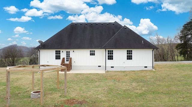 back of house with a patio area and a yard