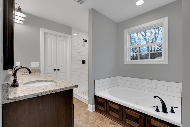 bathroom with tile patterned flooring, vanity, and separate shower and tub