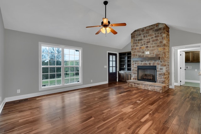 unfurnished living room with a fireplace, dark hardwood / wood-style floors, ceiling fan, and lofted ceiling