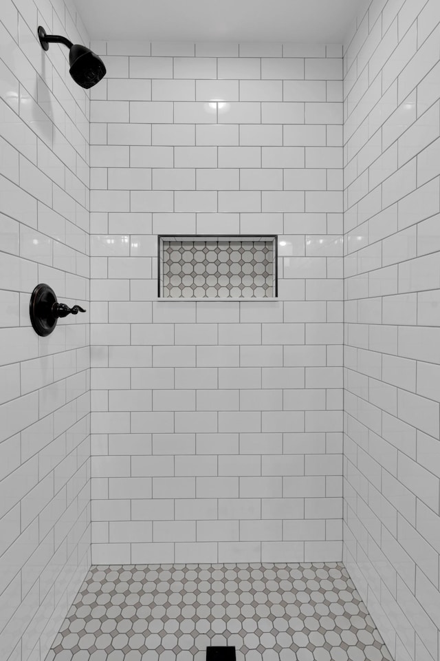 bathroom with a tile shower