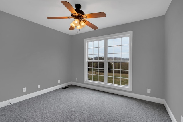 spare room featuring carpet and ceiling fan