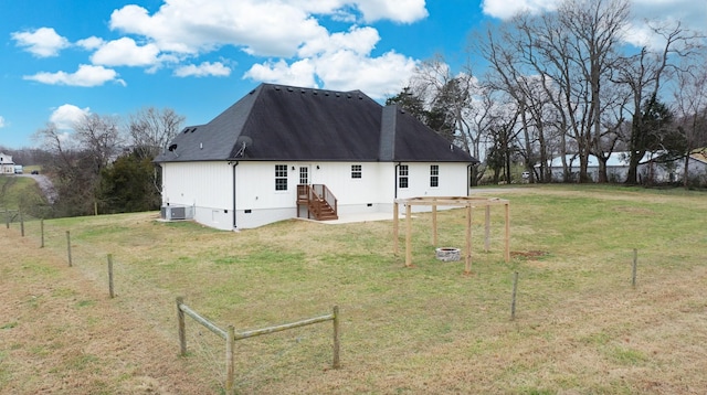 back of house featuring a lawn and central AC