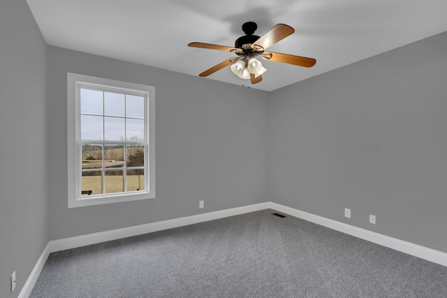 carpeted spare room with ceiling fan