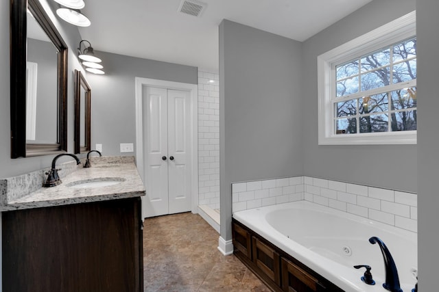 bathroom with a washtub and vanity