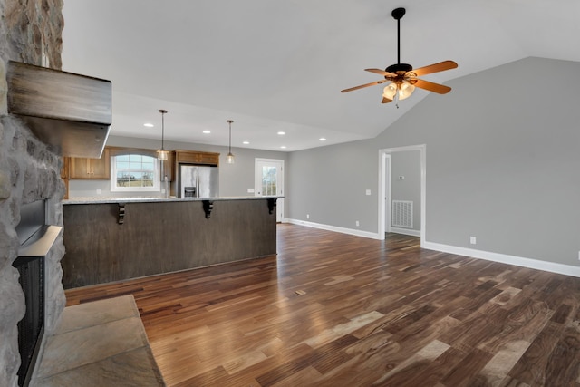 unfurnished living room featuring dark wood-type flooring, a wealth of natural light, and vaulted ceiling