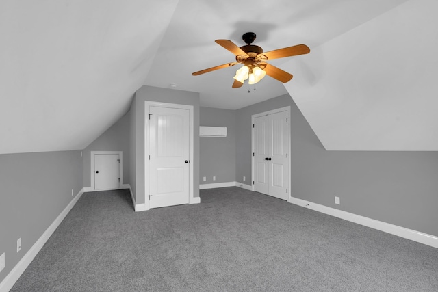 bonus room with ceiling fan, carpet floors, a wall unit AC, and vaulted ceiling