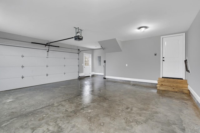 garage featuring electric panel and a garage door opener