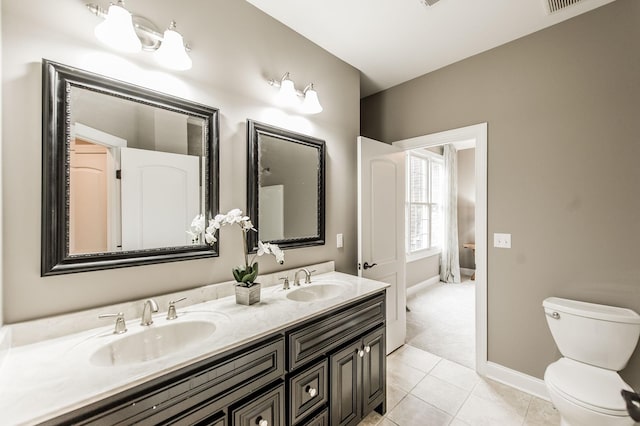 bathroom with tile patterned floors, vanity, and toilet