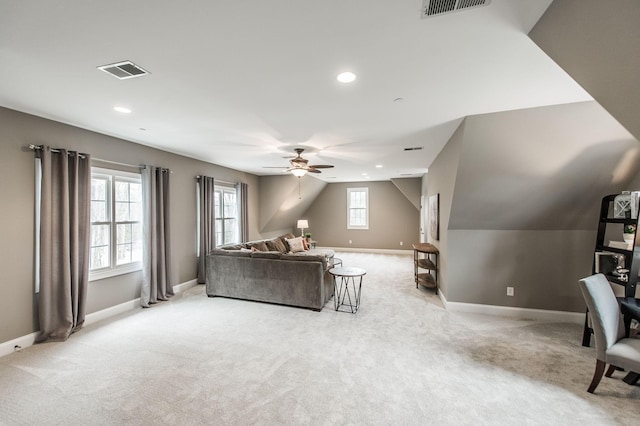 carpeted living room featuring ceiling fan and lofted ceiling