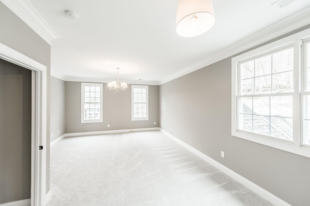 carpeted spare room with crown molding and a notable chandelier