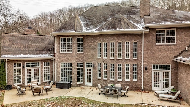 rear view of property with french doors, a patio, and an outdoor hangout area