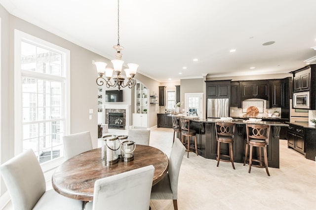 dining space featuring ornamental molding and a chandelier