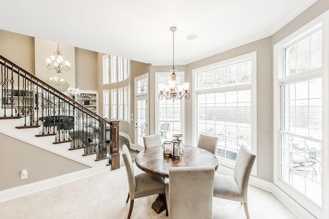 dining space featuring crown molding, light tile patterned flooring, and an inviting chandelier