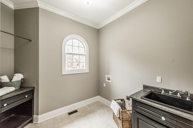 laundry area featuring ornamental molding, sink, and hookup for a washing machine