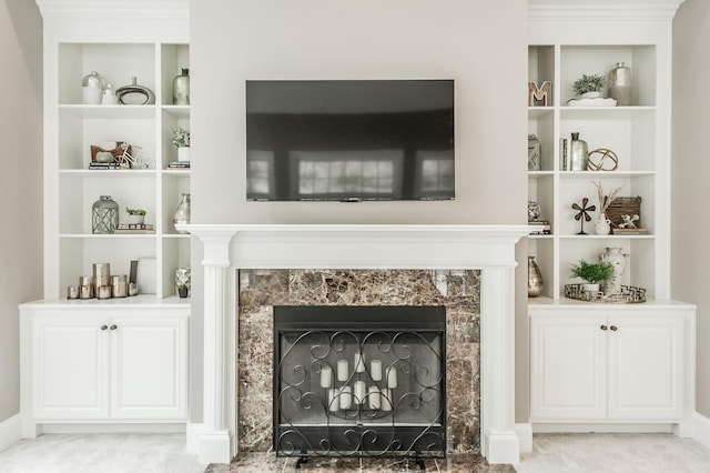 room details with a fireplace, carpet flooring, and built in features